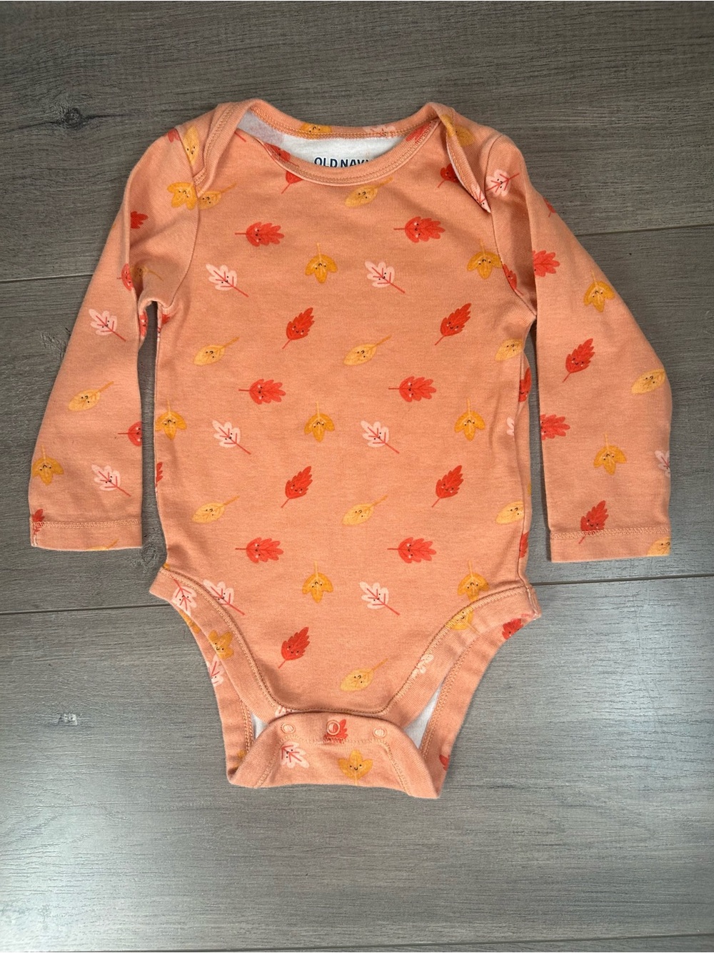 Old Navy long-sleeve baby bodysuit featuring an autumn leaf print - Size: 6-12 m